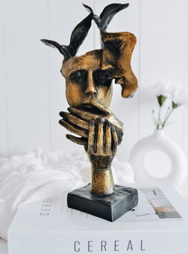 pexels-photo-12771321-12771321 Elegant bronze sculpture of an abstract face on a book with a modern and minimalist touch.
