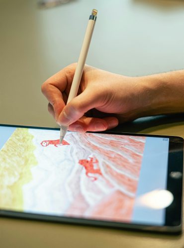 pexels-photo-4238493-4238493 Close-up of hand drawing on tablet screen with stylus, showcasing digital artistry.