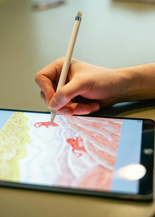 pexels-photo-4238493-4238493 Close-up of hand drawing on tablet screen with stylus, showcasing digital artistry.